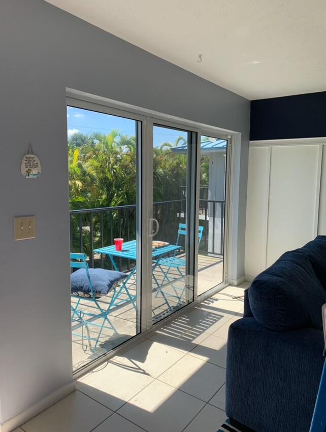 1180 Carlton Court, Unit 204B Fort Pierce, FL 34949 - Photo 19 of 19 a living room with couch and a floor to ceiling window