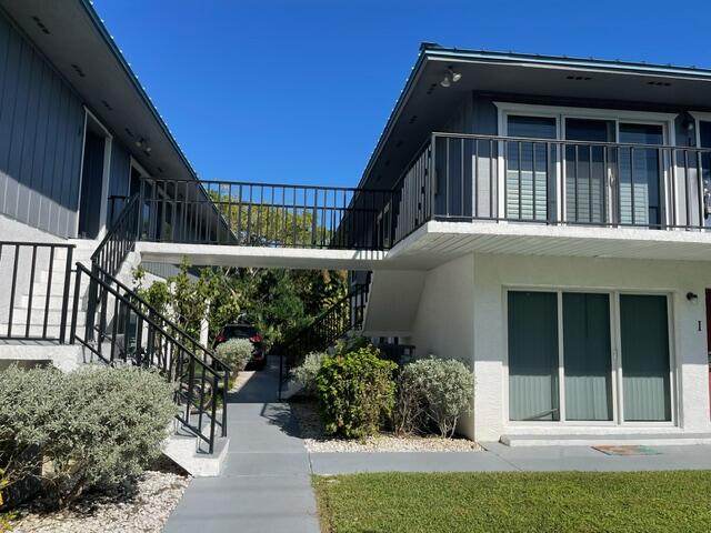 1180 Carlton Court, Unit 204B Fort Pierce, FL 34949 - Photo 2 of 19 a view of a small house with potted plants and wooden fence