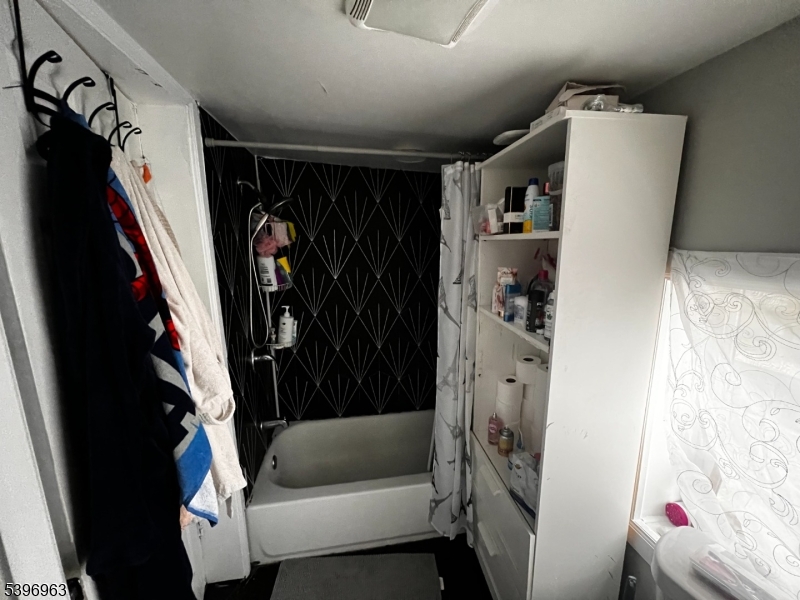 149 Smith Street Newark, NJ 07106 - Photo 14 of 20 a view of walk in closet with clothes and shoes