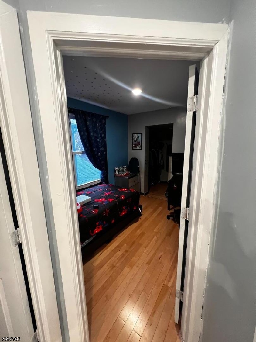 149 Smith Street Newark, NJ 07106 - Photo 15 of 20 a room with a bed and a mirror