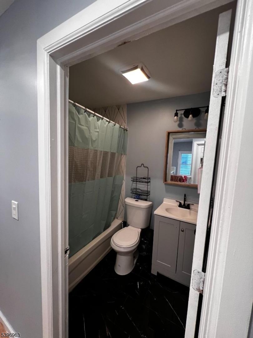 149 Smith Street Newark, NJ 07106 - Photo 7 of 20 a bathroom with a toilet sink and a shower