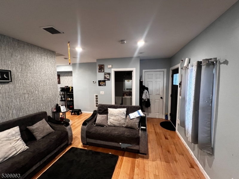 149 Smith Street Newark, NJ 07106 - Photo 8 of 20 a living room with furniture and a rug