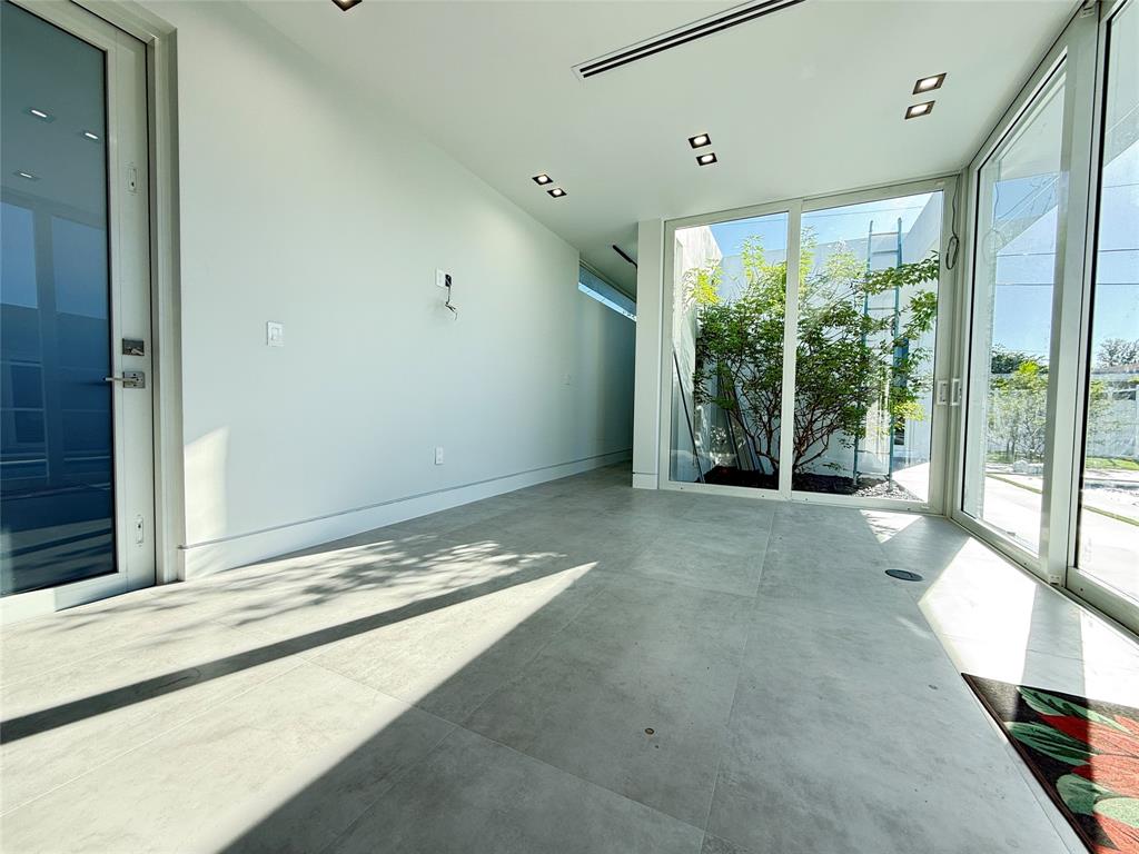 12245 Southwest 29th Terrace Miami, FL 33175 - Photo 11 of 23 a view of an empty room with wooden floor and a window