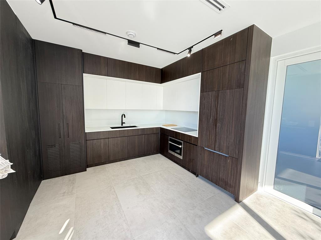 12245 Southwest 29th Terrace Miami, FL 33175 - Photo 6 of 23 a kitchen that has a sink and a refrigerator