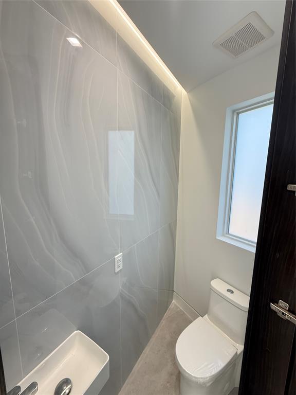 12245 Southwest 29th Terrace Miami, FL 33175 - Photo 7 of 23 a white toilet sitting next to a small bathroom