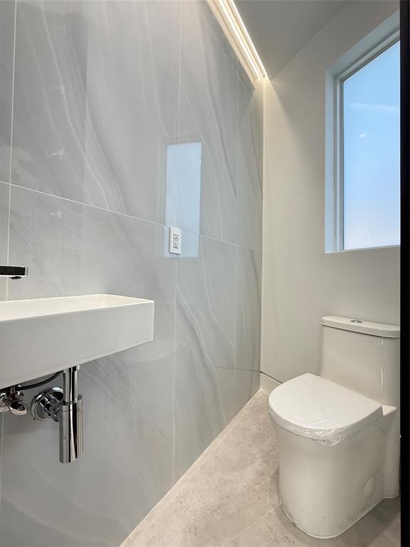 12245 Southwest 29th Terrace Miami, FL 33175 - Photo 8 of 23 a white toilet sitting next to a bathroom sink