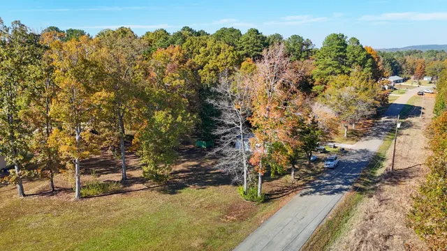 a view of a yard with wooden fence