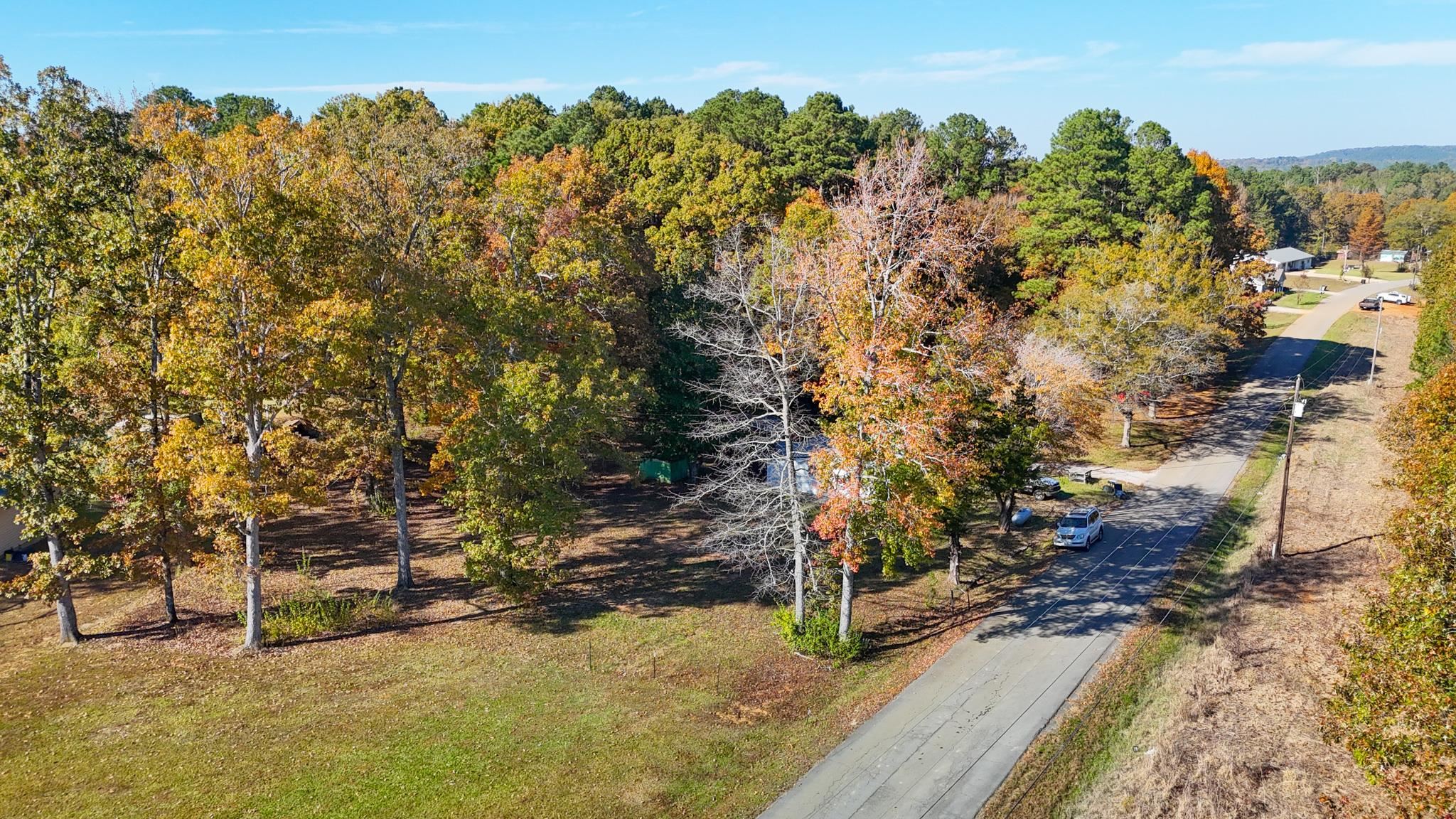 a view of a yard with wooden fence