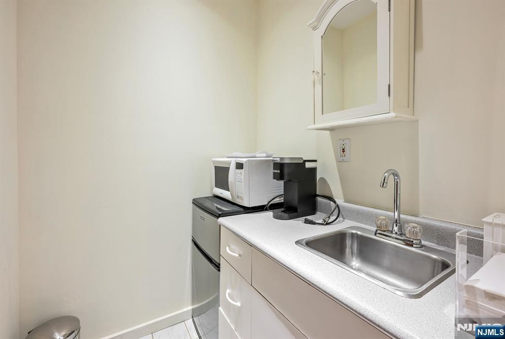 84 Bogerts Mill Road Harrington Park, NJ 07640 - Photo 44 of 47 a kitchen with a sink and cabinets