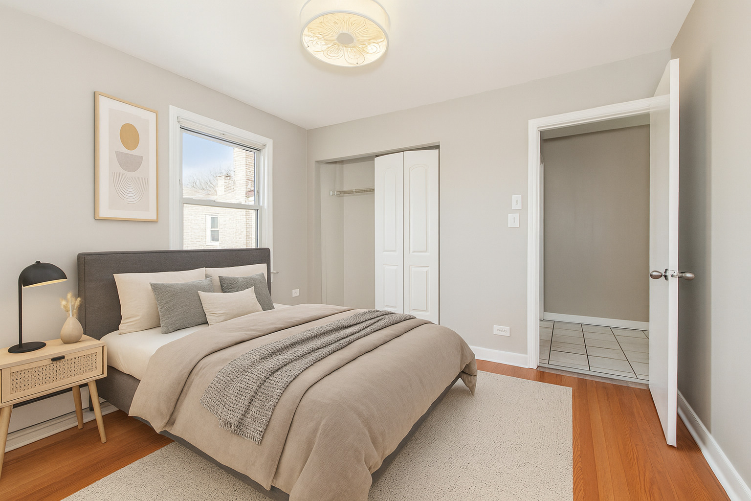 2645 West Gregory Street, Unit 2W Chicago, IL 60625 - Photo 6 of 9 a bedroom with a bed and wooden floor