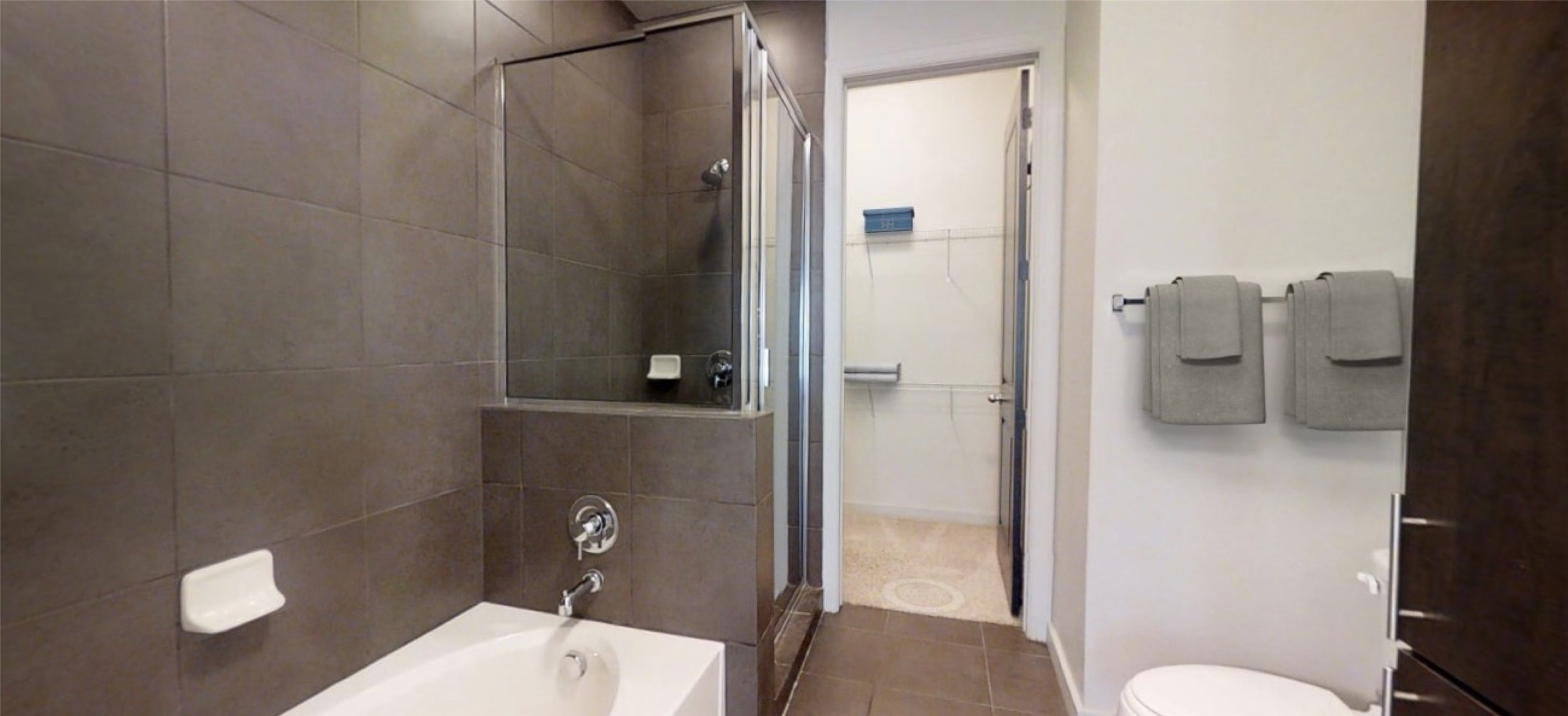 2525 McCue Road, Unit 125 Houston, TX 77056 - Photo 9 of 35 a bathroom with a granite countertop shower a toilet and a sink