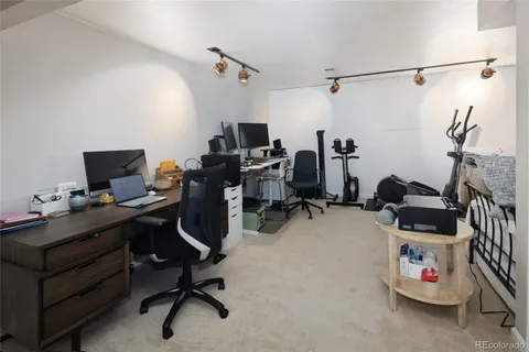 a living room with furniture a flat screen tv and a window