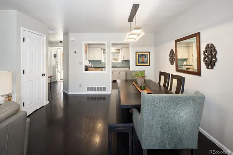 a living room with furniture and a painting on the wall