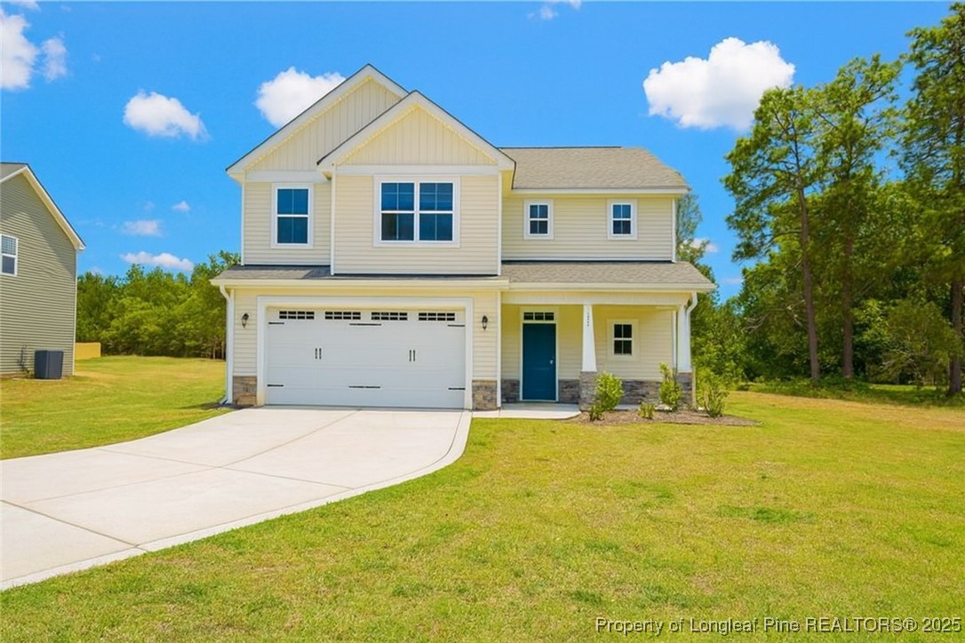 2937 Lemuel Black Road Spring Lake, NC 28390 - Photo 2 of 32 a front view of a house with a yard and garage