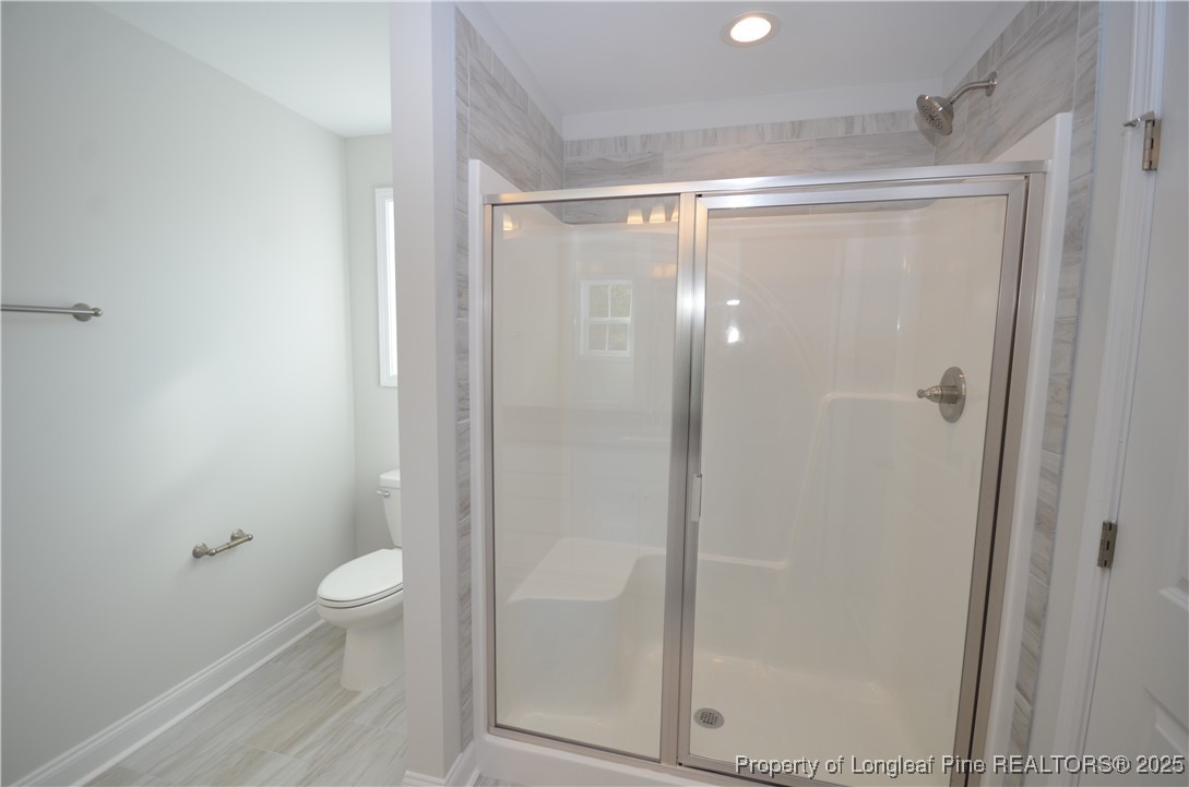 2937 Lemuel Black Road Spring Lake, NC 28390 - Photo 28 of 32 a bathroom with a shower a toilet and a shower