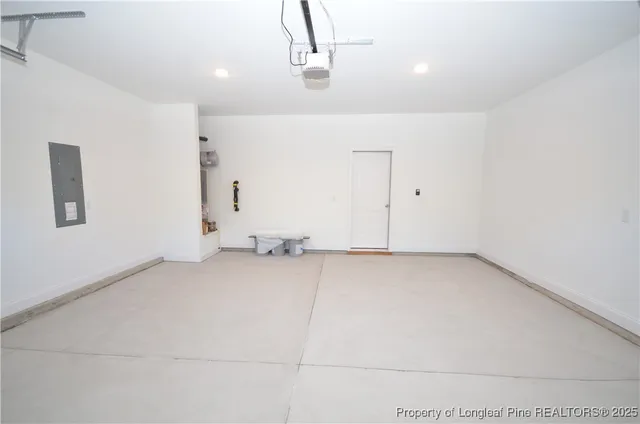 a front view of house with yard and trees in the background