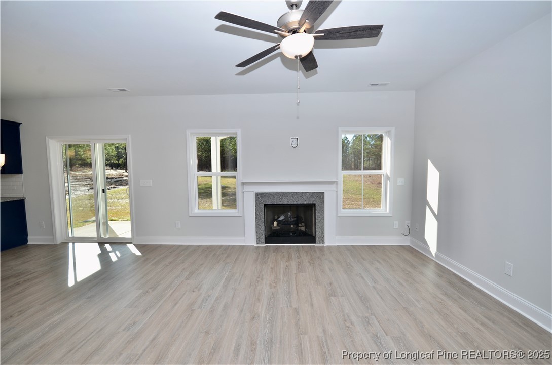 2937 Lemuel Black Road Spring Lake, NC 28390 - Photo 6 of 32 wooden floor fireplace and windows in an empty room
