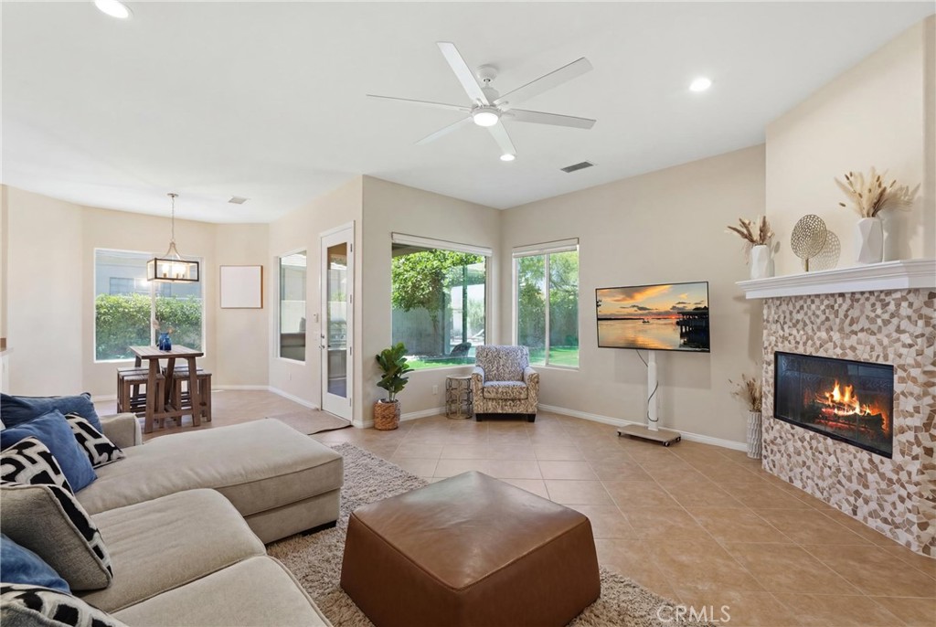 9 Orleans Road Rancho Mirage, CA 92270 - Photo 30 of 71 a living room with furniture a fireplace and a flat screen tv