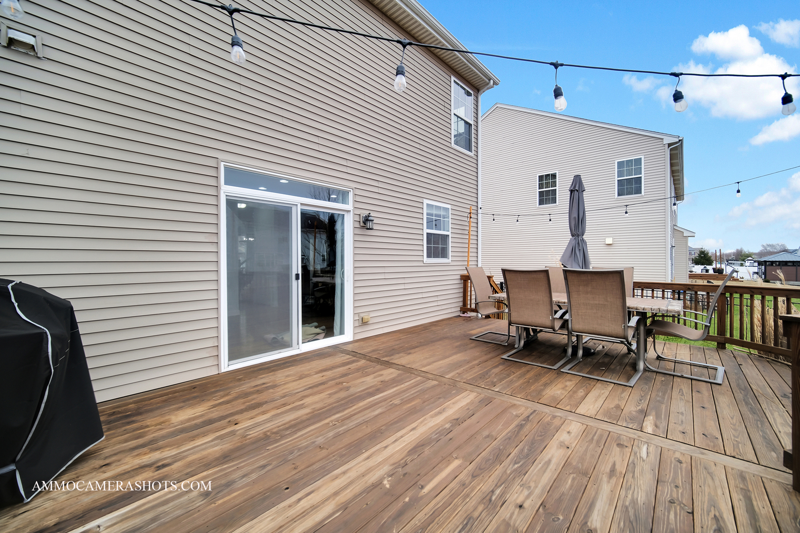 2305 Brookstone Drive Bolingbrook, IL 60490 - Photo 31 of 33 a backyard of a house with wooden floor chairs and a table