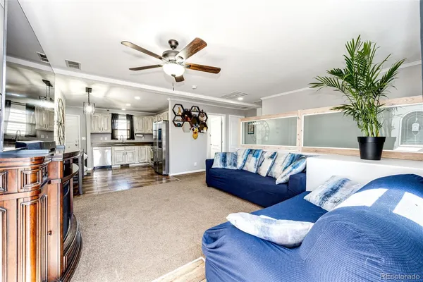 a living room with furniture and kitchen view