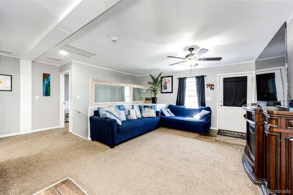 a living room with furniture and a chandelier
