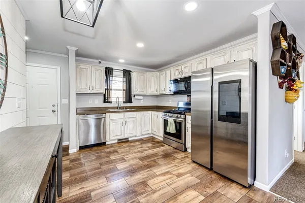 a kitchen with granite countertop a refrigerator and a sink