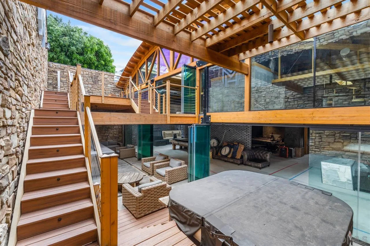843 Tenth Avenue, Unit A & B San Diego, CA 92101 - Photo 14 of 75 a view of a patio with table and chairs with wooden floor and fence