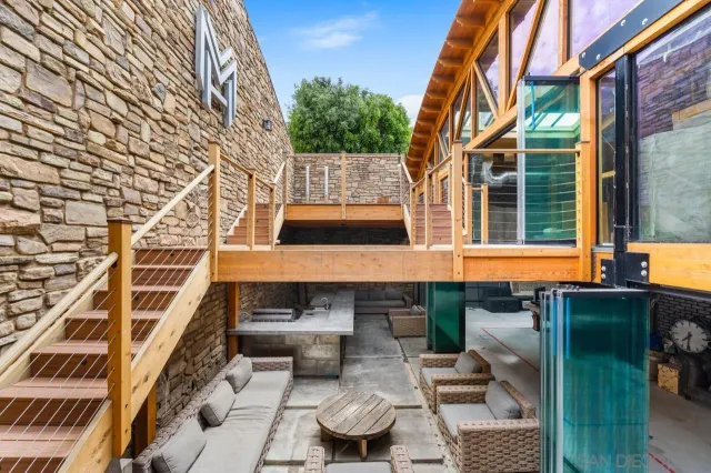 a view of a patio with couches and a table and chairs