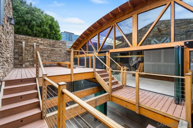 a view of room with wooden deck and furniture