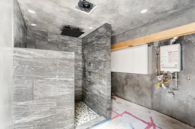 a roof deck with a table and a barbeque