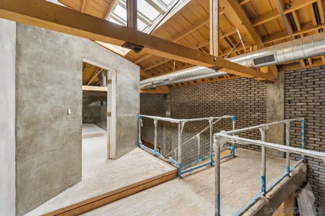 a balcony with furniture and a potted plant