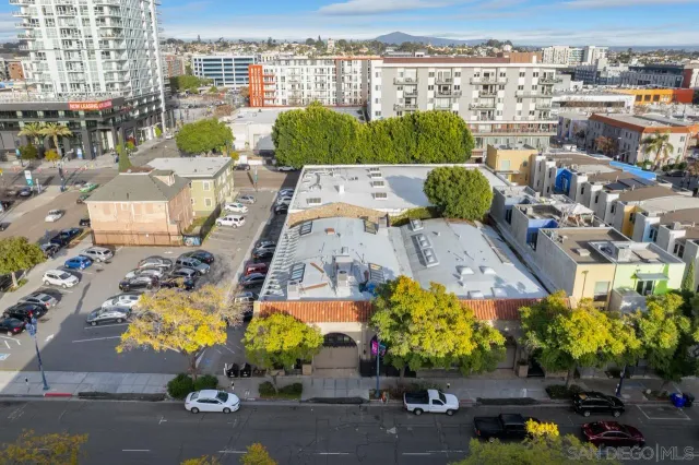 a view of a patio with couches and a dining table and chairs with wooden floor
