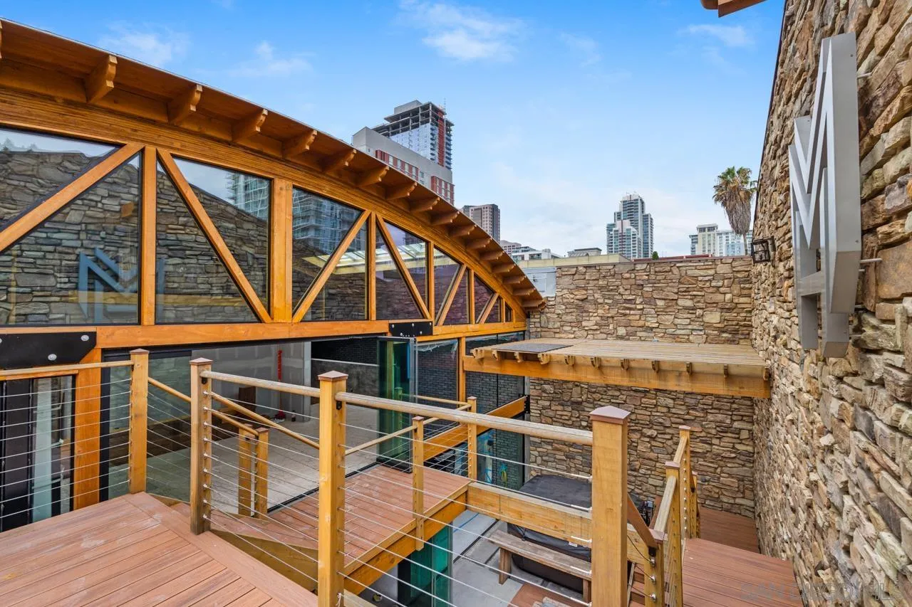 843 Tenth Avenue, Unit A & B San Diego, CA 92101 - Photo 10 of 75 a view of a balcony with wooden chairs and iron stairs