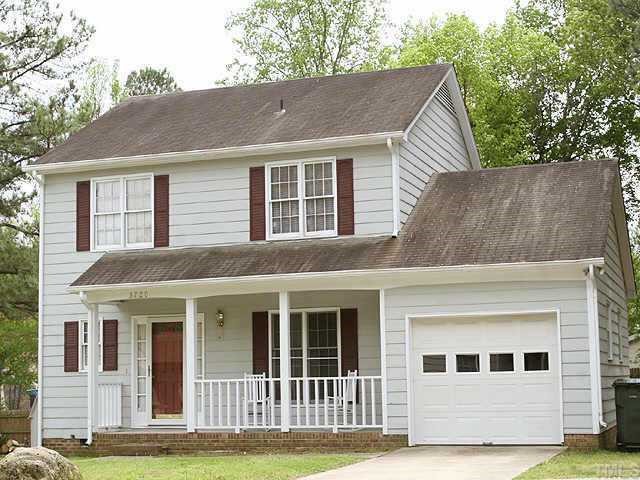 3720 Dusty Lane Raleigh, NC 27604 - Photo 2 of 11 a view of a white house with large windows and a yard