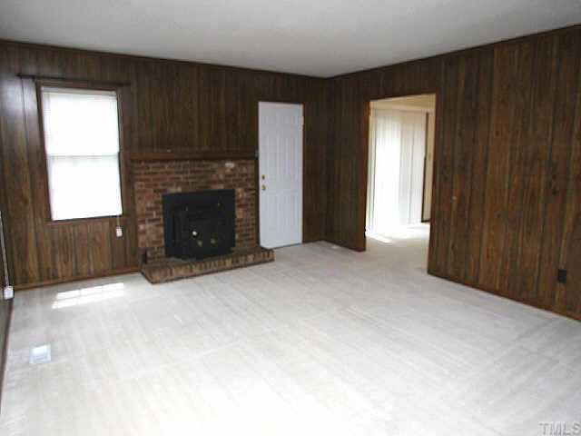 3720 Dusty Lane Raleigh, NC 27604 - Photo 3 of 11 an empty room with windows and a fireplace
