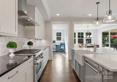 a large kitchen with kitchen island a sink table and chairs