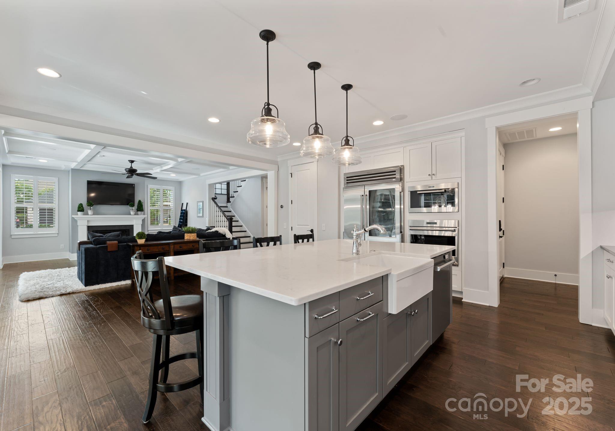 9043 Golden Rock Lane Huntersville, NC 28078 - Photo 25 of 48 a large kitchen with kitchen island a sink table and chairs