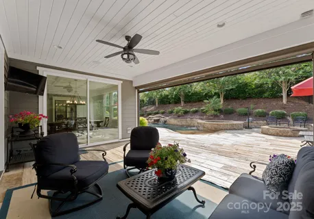 a living room with furniture and a ceiling fan