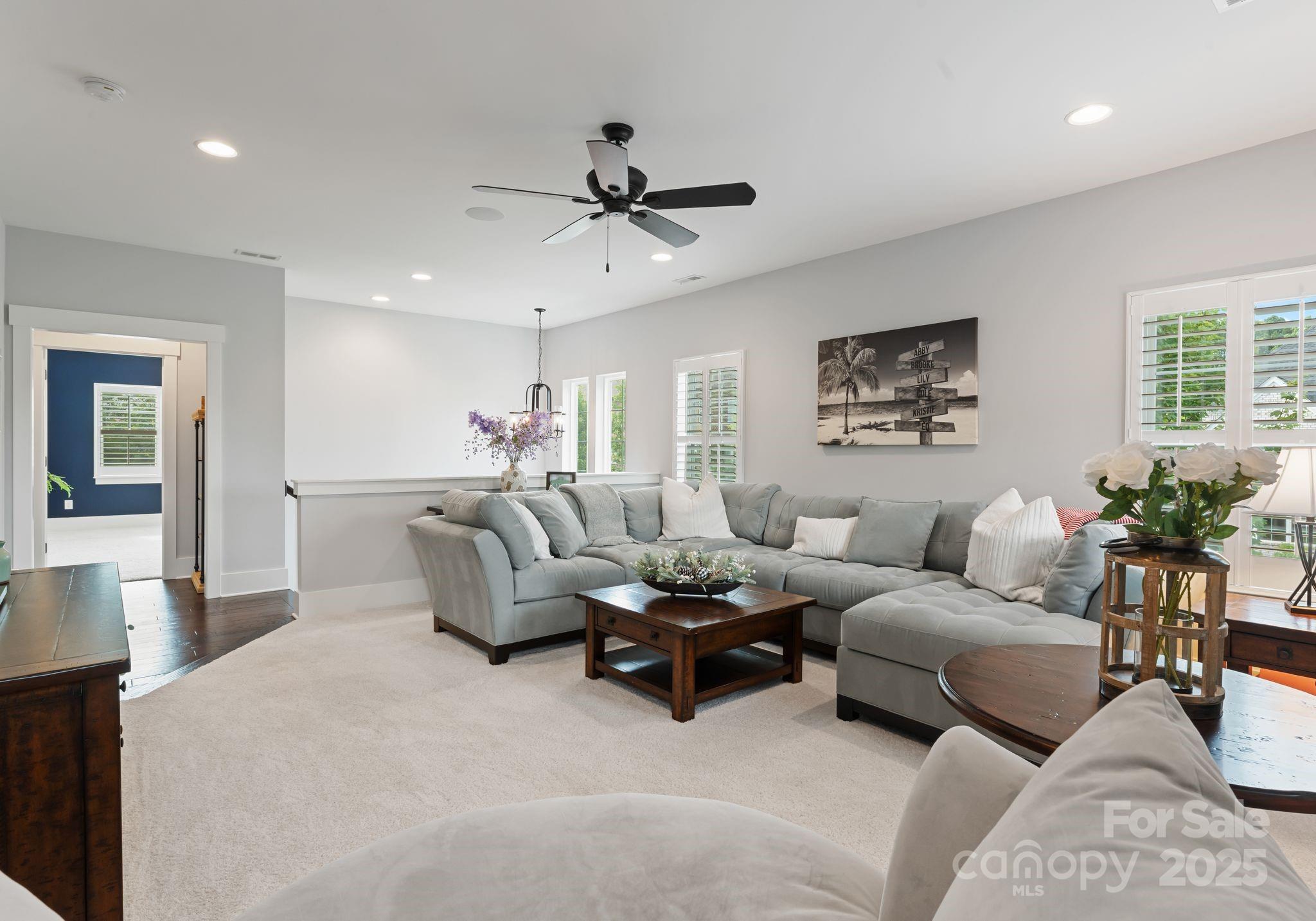 9043 Golden Rock Lane Huntersville, NC 28078 - Photo 30 of 48 a living room with furniture and a ceiling fan