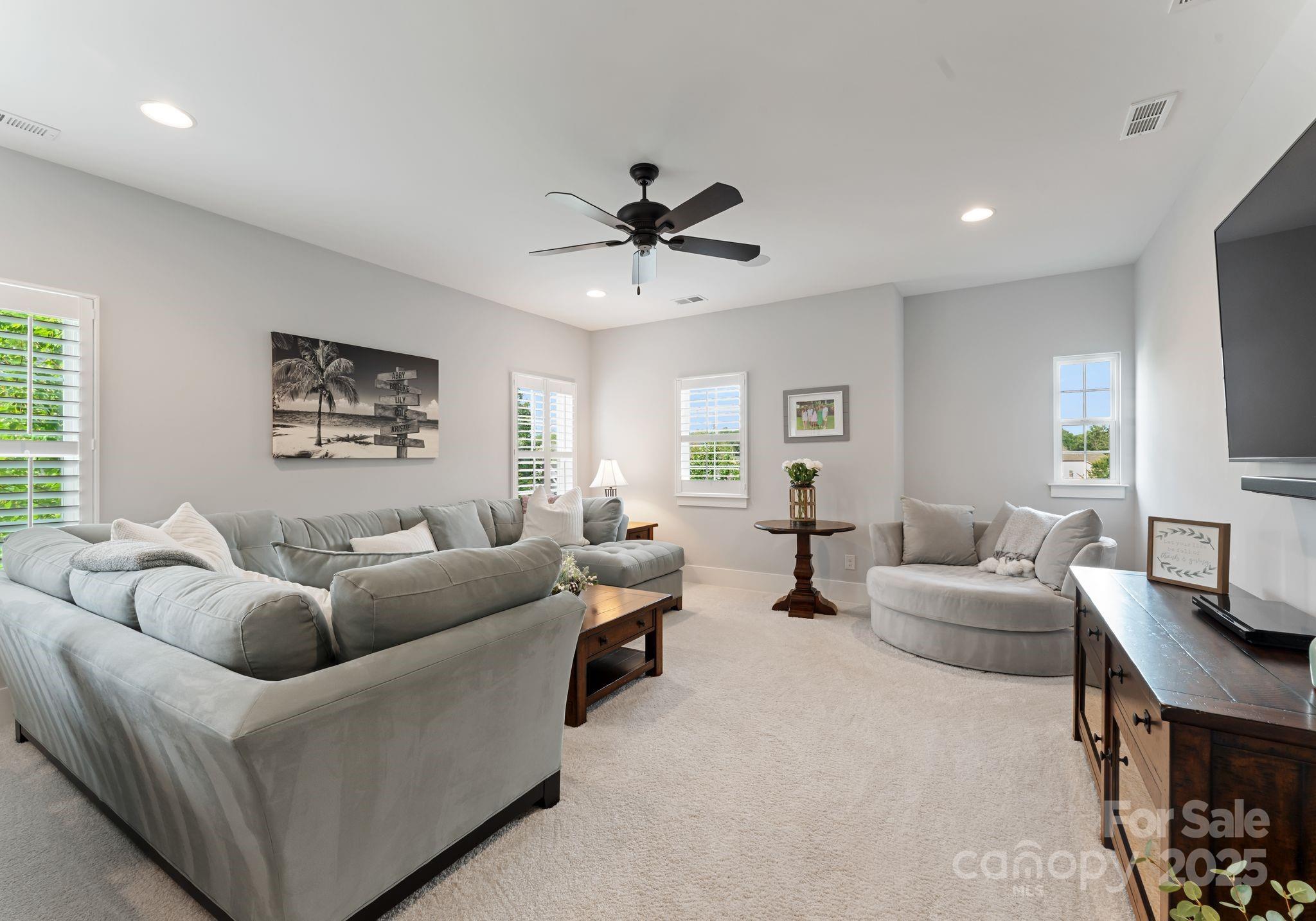 9043 Golden Rock Lane Huntersville, NC 28078 - Photo 31 of 48 a living room with furniture and a flat screen tv