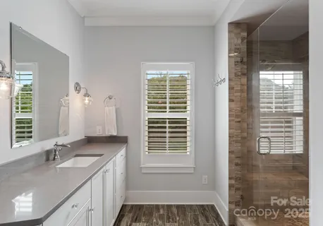 a bathroom with a granite countertop tub sink and window