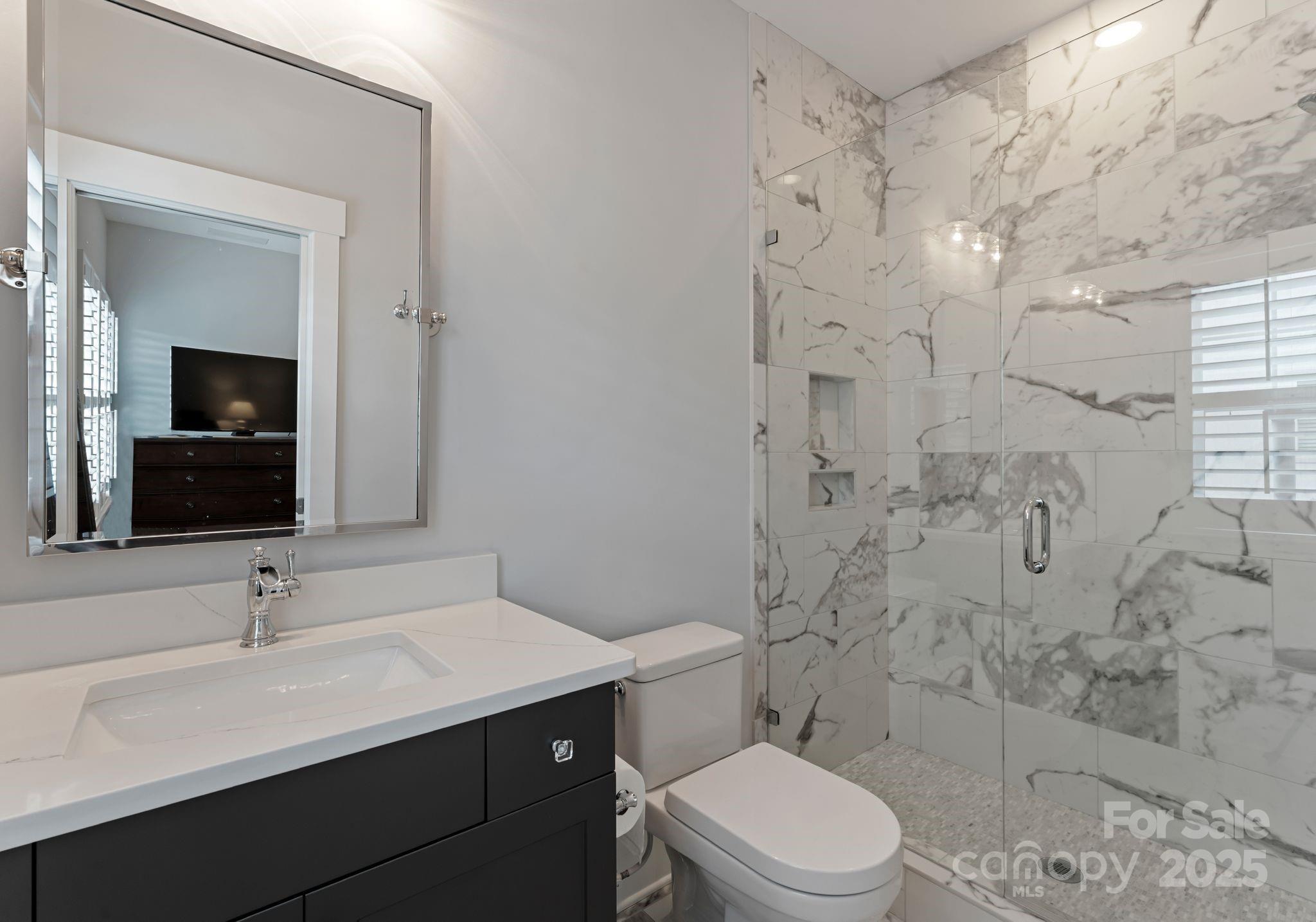 9043 Golden Rock Lane Huntersville, NC 28078 - Photo 37 of 48 a bathroom with a sink a toilet and shower