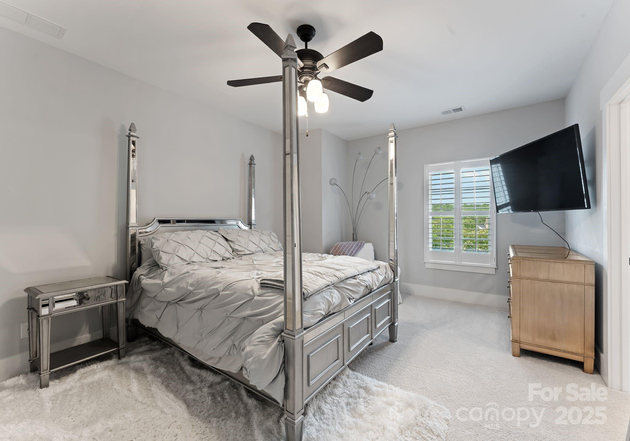 9043 Golden Rock Lane Huntersville, NC 28078 - Photo 40 of 48 a bedroom with a bed and a flat screen tv