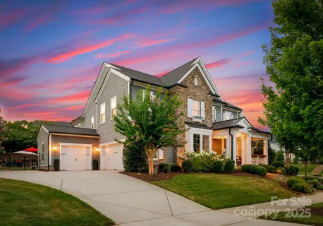 a front view of a house with a garden and yard