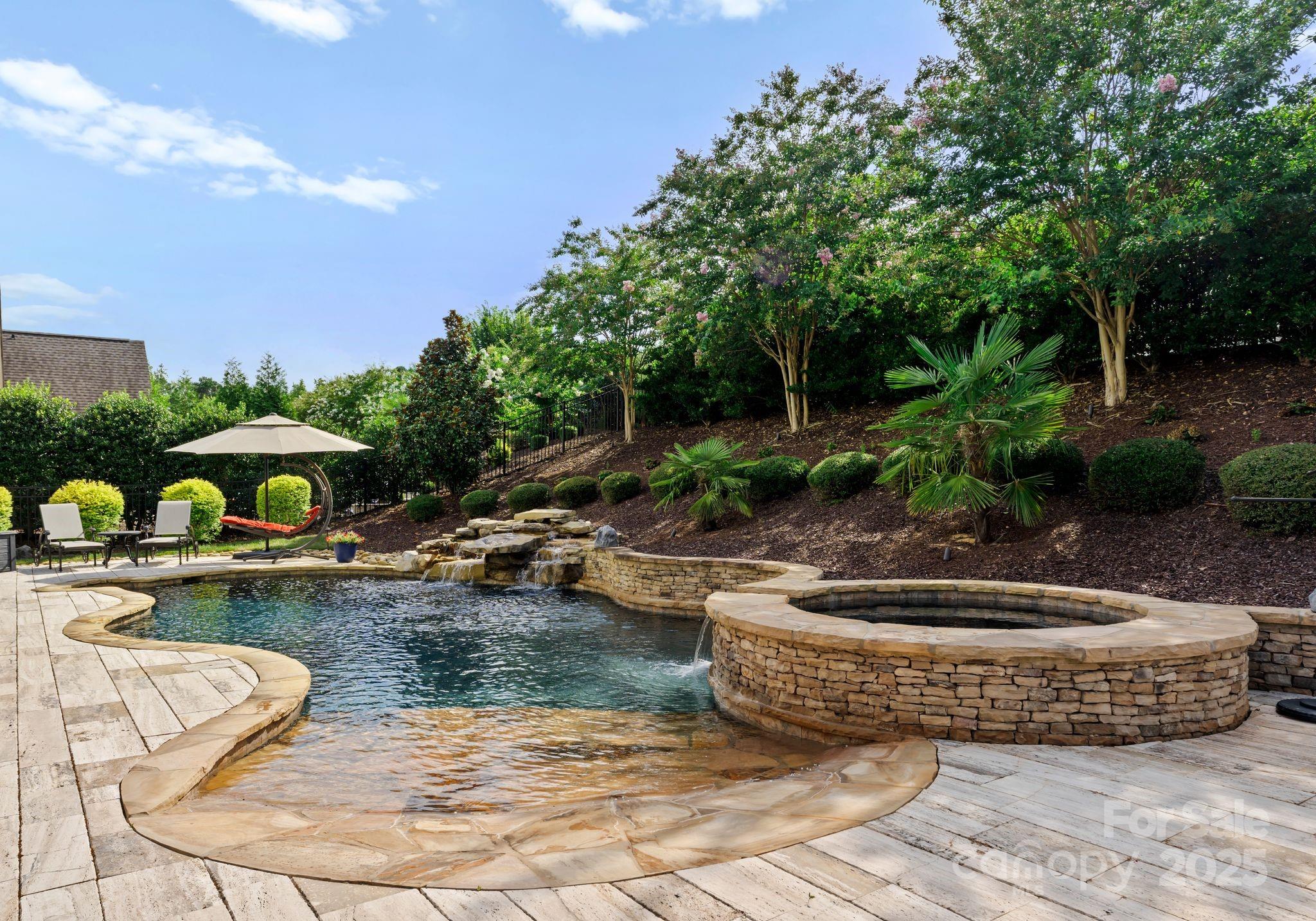 9043 Golden Rock Lane Huntersville, NC 28078 - Photo 45 of 48 a view of a swimming pool with lawn chairs plants and large trees