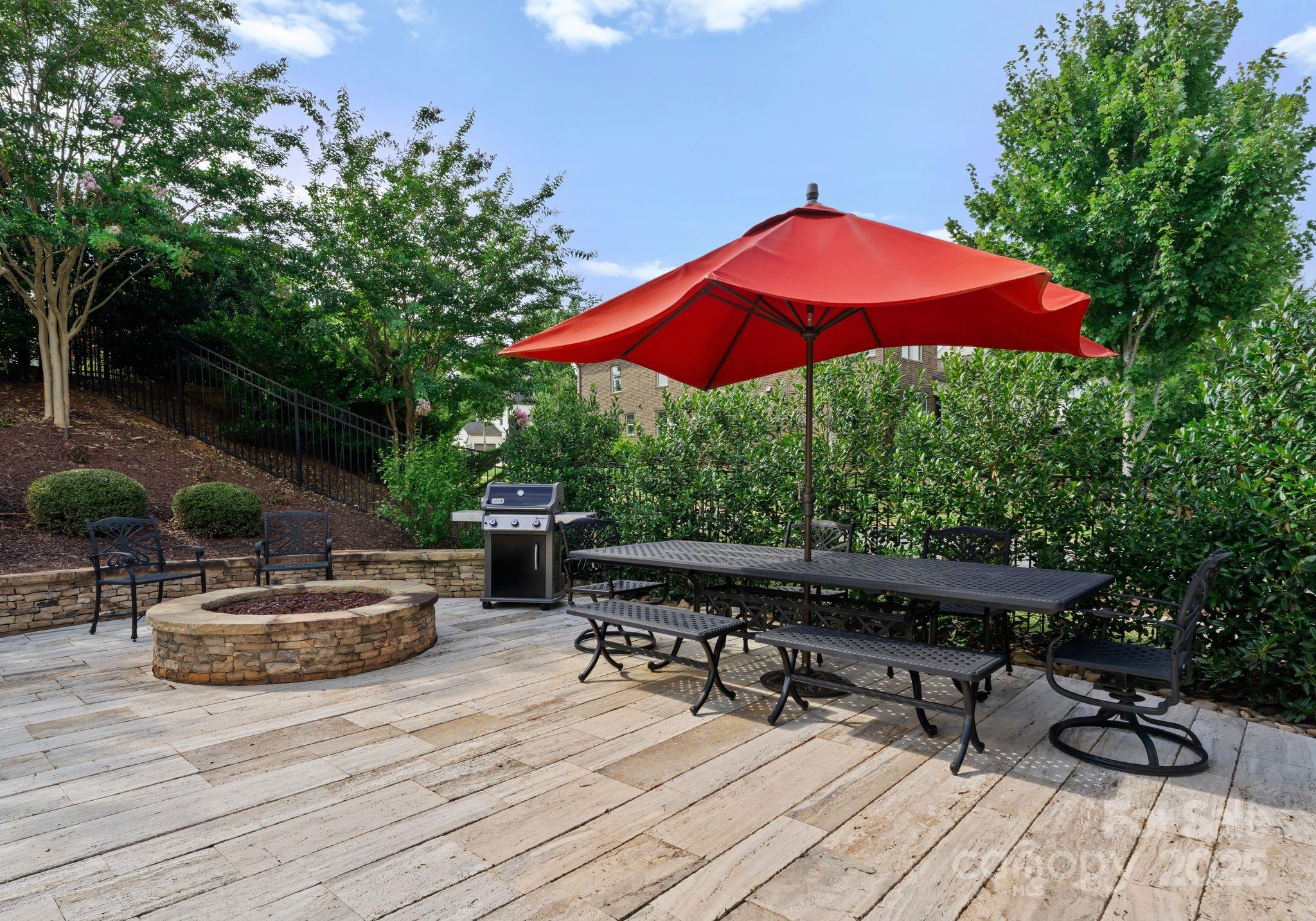9043 Golden Rock Lane Huntersville, NC 28078 - Photo 46 of 48 a view of backyard with table and chairs under an umbrella