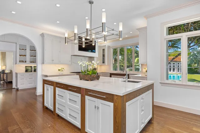 a kitchen with a stove and white cabinets