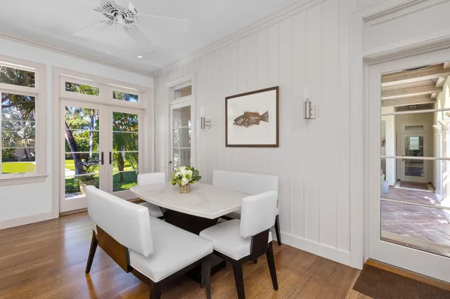 a kitchen with white cabinets and sink