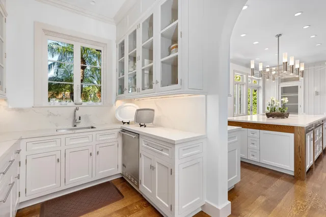 a living room with furniture a fireplace and a chandelier