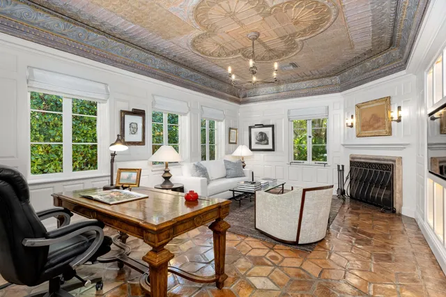 a living room with furniture a fireplace and a large window